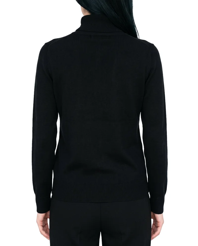 A woman is shown from the rear in a torso crop wearing a black turtleneck, with her arms relaxed. The garment is presented against a pure white backdrop.