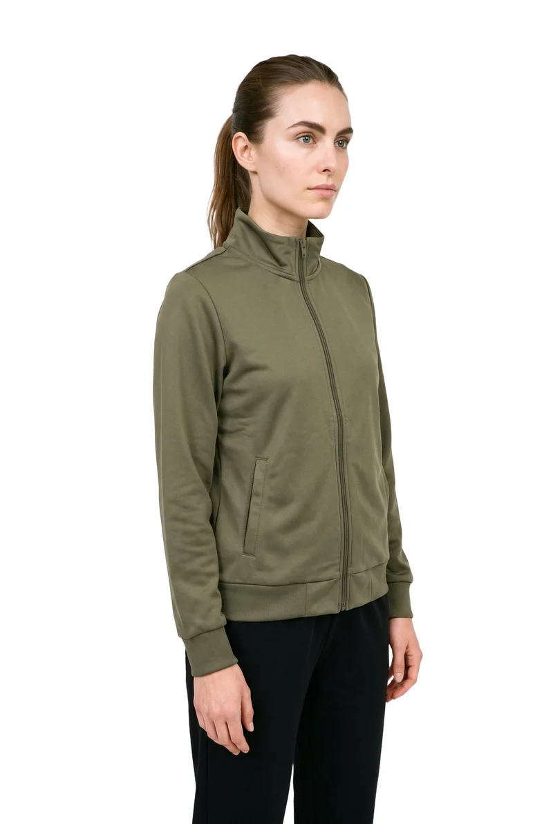 A 29-year-old Caucasian woman stands straight in a three-quarter-length, angled front view wearing a women's olive tracksuit top. Her expression is neutral, and a pure white backdrop frames the garment.