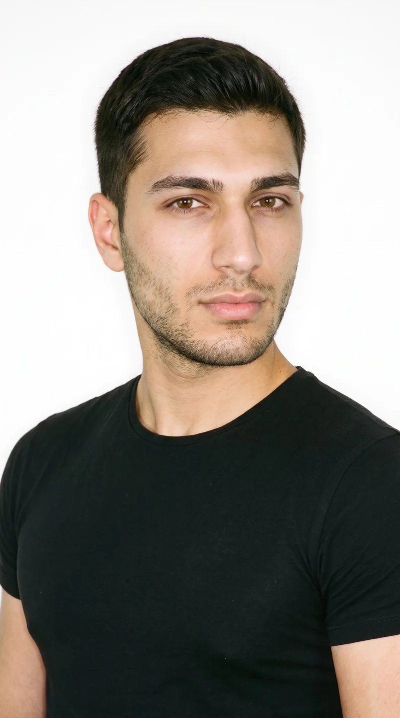 A 22-year-old Turkish man with medium olive skin and a neutral, greenish-golden undertone. His face has balanced oval proportions with a softly rounded jaw, medium-thickness eyebrows, brown eyes, and full lips. He has dark-brown hair in a short tapered crew cut, slightly longer on top than at the sides, with fine closely trimmed stubble lightly covering the beard area.