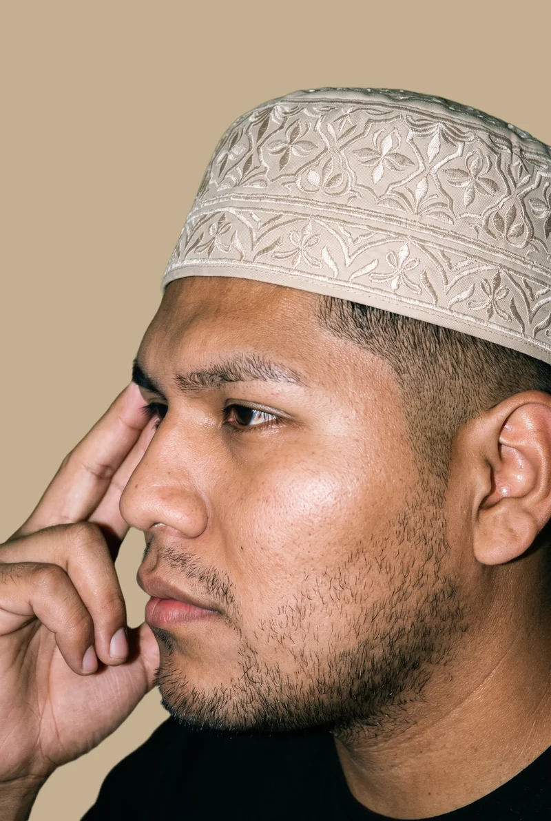 Beige Embroidered Kufi, Head at Side, Studio Cutout lighting