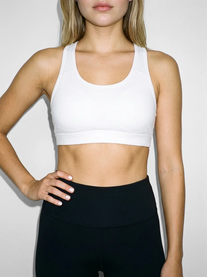 White Padded Sports Bra, Torso at Front, Clean Catalog lighting