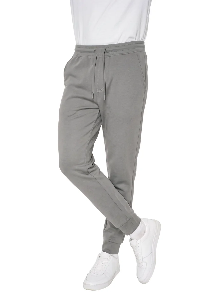 Men's Grey Tapered Performance Joggers, Lower body at Angled front, Studio Cutout lighting