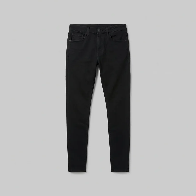 Men's black skinny jeans are shown laid flat in a mostly complete front view. The jeans have a mid-rise waistband, belt loops, a centered button, a fly placket, curved front pockets, a coin pocket on the wearer's right, pocket-corner rivets, visible topstitching, narrow tapered full-length legs, and plain stitched hems.