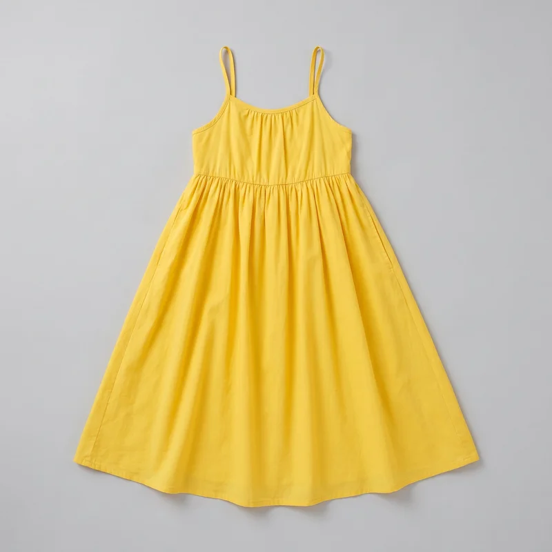 A complete flat-lay view of a yellow sleeveless sundress. It has narrow shoulder straps, a curved scoop neckline with bound edging, slightly curved armholes, a fitted bodice with visible gathering, a horizontal waist seam, and a full gathered skirt that flares away from the waist to a wide stitched hem. Side seam lines are visible, with no visible closures, pockets, logos, prints, patches, embroidery, or embellishments.