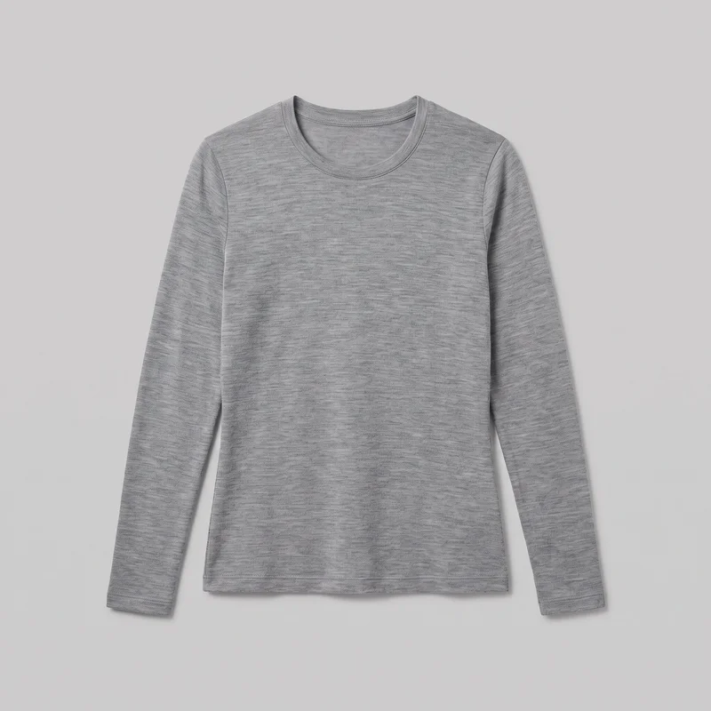 A grey merino thermal top is laid flat in a standalone front view. It has a regular straight silhouette, set-in shoulders, full-length sleeves, a narrow bound crew neckline with visible rows of stitching, stitched turnback cuffs and a straight bottom hem, with a fine even heathered knit surface.
