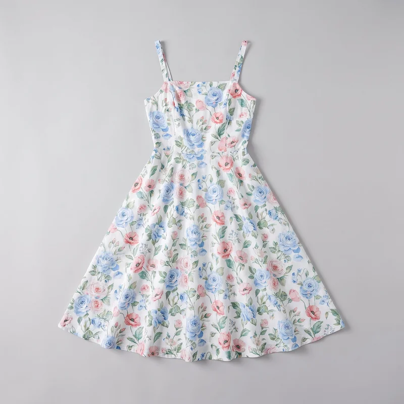 A complete flat-lay view shows a women's sleeveless sundress with narrow shoulder straps, a straight square neckline, a fitted bodice, and a defined waist seam. The skirt flares into a wide A-line midi-length silhouette with visible vertical panel seams. An all-over watercolor-style botanical print of flowers and leaves covers the dress, with no visible logos, text, closures, or pockets.