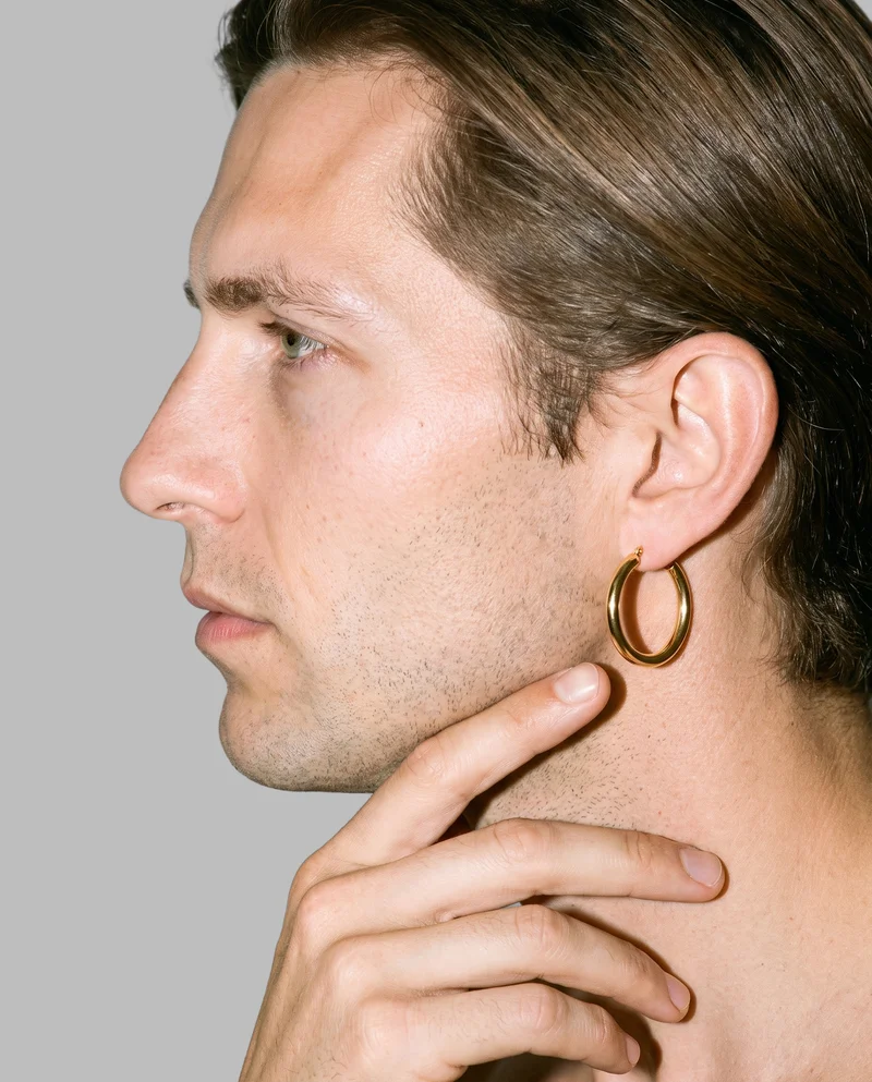 Men's Large Gold Hoop Earrings, Ear at Side, Studio Cutout lighting