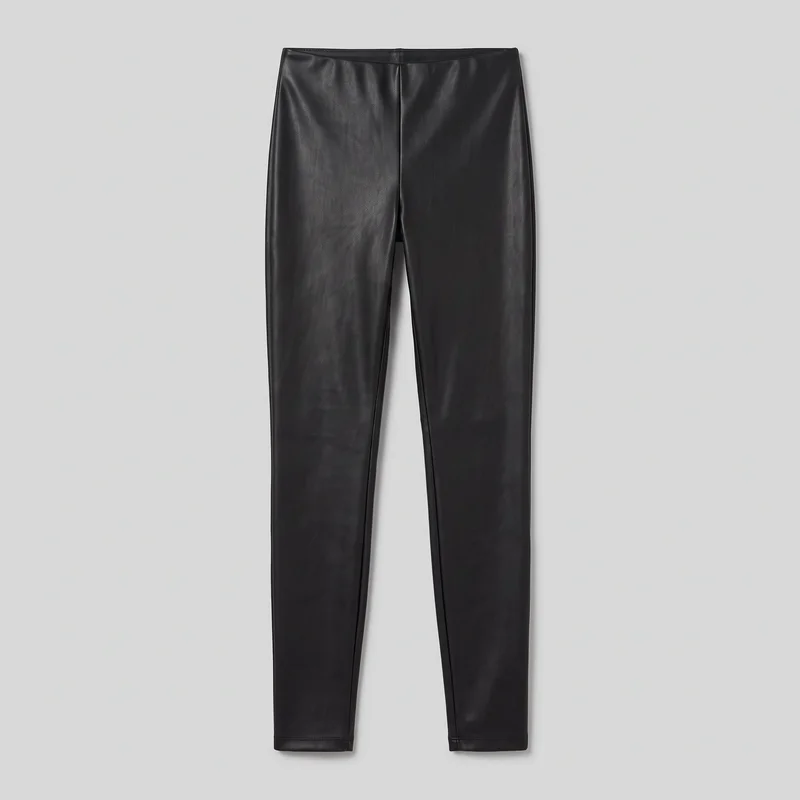Black faux-leather leggings are shown in a full front flat-lay view. The slim, close-fitting pants have a straight waistband, center front rise seam, narrow tapered legs, subtle outer-leg seam edging, and straight stitched hems. No pockets, external closure, logos, or embellishments are visible.