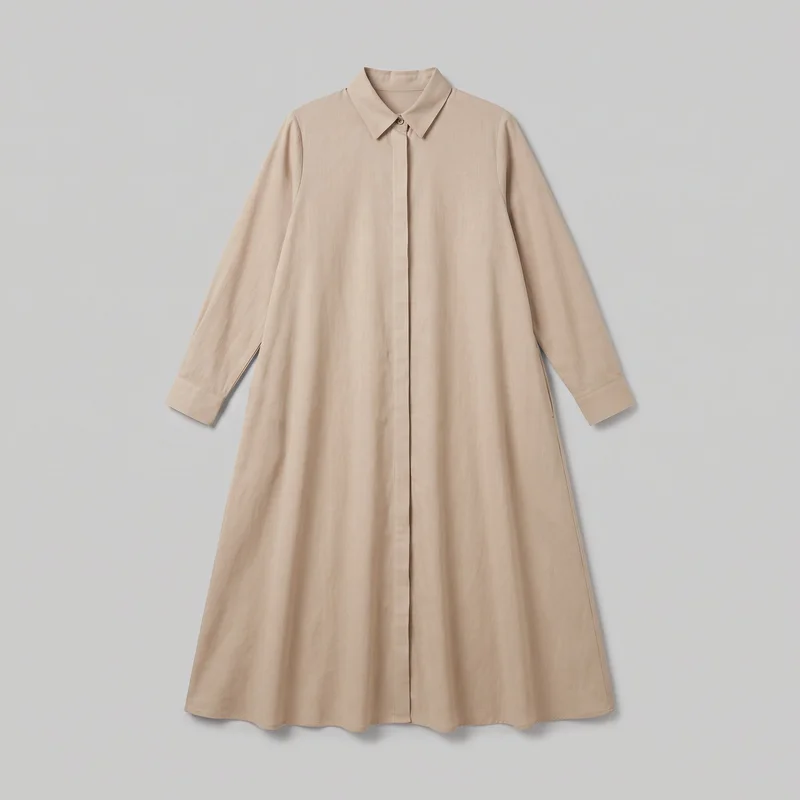 Beige women's shirt dress shown laid flat in a mostly complete front view. It has a pointed collar, set-in long sleeves with stitched cuffs, a centered button closure with a visible top button and concealed placket, a relaxed A-line silhouette, and a wide gently flared skirt ending in a straight full-length hem.