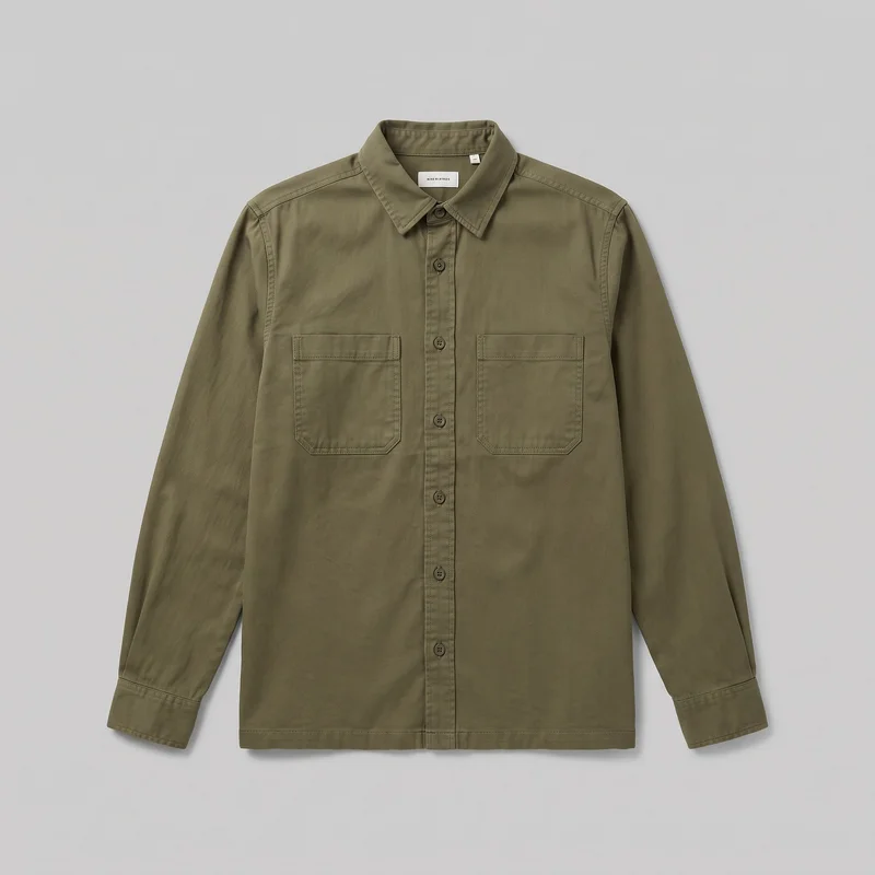 Olive cotton utility overshirt shown laid flat in a mostly complete front view. The long-sleeve shirt has a pointed turn-down collar, round buttons along the full front placket, two chest patch pockets with angled lower corners, straight cuffs, and a straight full-length hem.