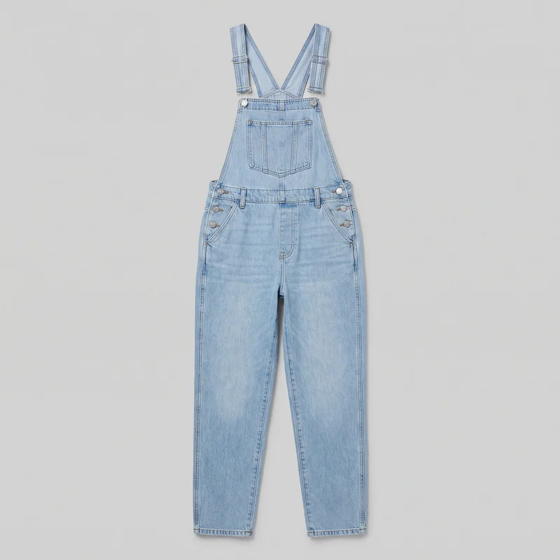 Light wash denim bib-and-brace overalls are shown in a complete front flat-lay view. The relaxed full-length garment has a straight-leg cut, raised bib, deep V-shaped strap opening, wide adjustable shoulder straps with slider buckles, and a large divided patch chest pocket. Visible details include belt loops, curved hip pockets, stacked side button closures with rivets, a fly seam, contrast topstitching, and straight hems.