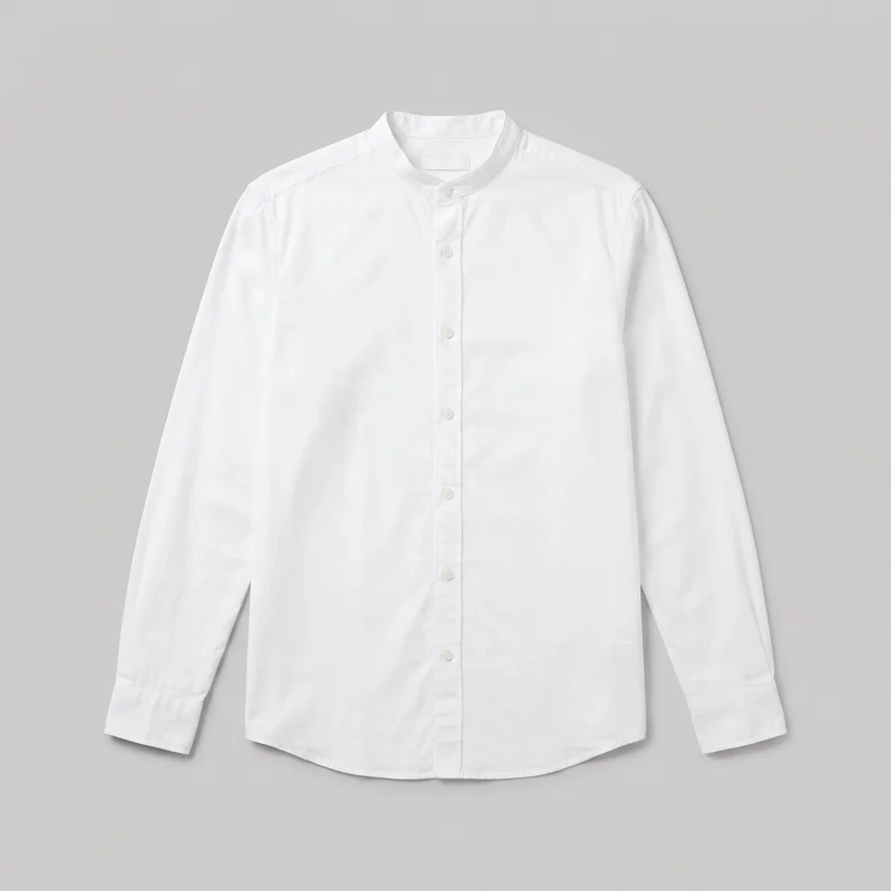 A white adult long-sleeve button-up shirt is shown centered in a standalone front view. It has a band collar, full center-front button placket, set-in shoulders, buttoned cuffs, a straight regular silhouette, and a gently curved shirttail hem, with no visible pockets, logos, prints, patches, embroidery, or embellishments.