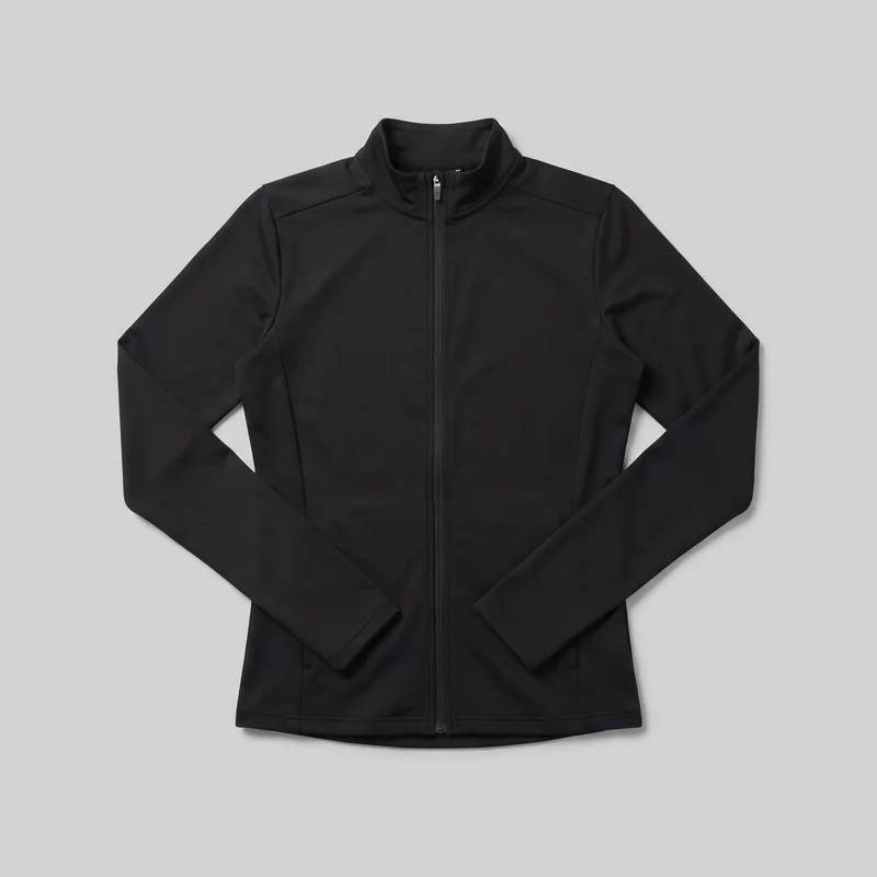 A black women's tracksuit top is shown laid flat in a front-facing standalone view. It has a full-length centered zipper, an upright stand collar, long set-in sleeves, shaped front panel seams, horizontal shoulder yoke seams, subtly integrated lower front pockets, and a straight hem with topstitching.