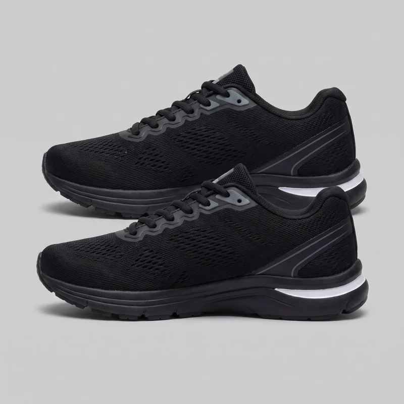 A pair of women's black low-top lace-up running sneakers is shown in lateral side view. The shoes have streamlined rounded-toe profiles, padded collars and tongues, ribbed uppers with elongated ventilation openings, wavy eyestay overlays, flat laces, translucent-looking eyelet panels, curved side stripes, structured heel counters, and thick layered soles with raised heels and segmented tread. The lower shoe is partly cropped.