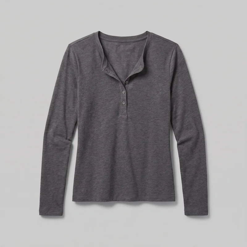A charcoal long-sleeve henley top is shown as a mostly complete standalone flat product view, centered and unworn. The front body, full-length slim sleeves, straight hem, bound round split neckline, short partially open three-button placket, reinforced placket base, shoulder seams, narrow sleeve cuffs, and stitched bottom hem are visible.