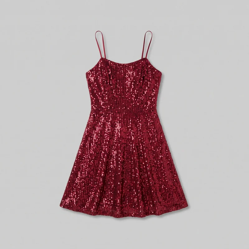 A mostly complete front-facing view of a red sequined cocktail dress. It has slender spaghetti straps, a shallow curved scoop neckline, a fitted paneled bodice with a defined horizontal waist seam, and a short A-line skirt that flares away from the waist to a slightly wavy straight hem. Dense all-over sequins create vertical textural striping across the dress.