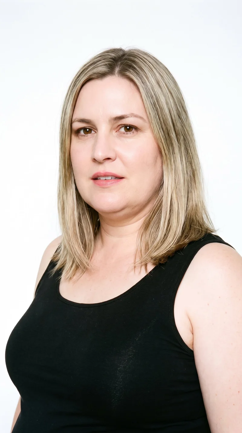 A 46-year-old Caucasian woman with porcelain skin and a neutral undertone has a square, angular face defined by a strong jaw and broad forehead. Her eyebrows are thin, and her eyes are brown. She has medium lips and wears her darker, slightly muted blonde hair in a long bob falling between the chin and shoulders.
