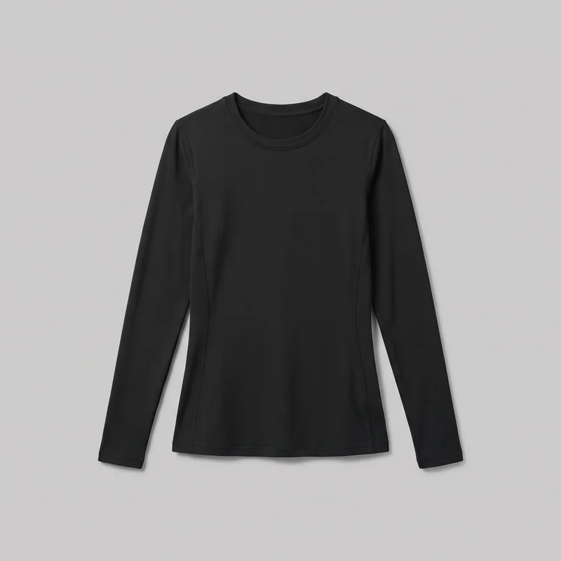 A black women's compression base layer top is shown laid flat in a front-facing standalone view. The full-length garment has a slim, body-skimming silhouette, long set-in sleeves, a rounded bound crew neckline, narrow shoulder and arm seams, curved vertical panel seams from the upper chest and underarm area toward the hem, stitched sleeve hems, and a straight stitched bottom hem. No closures, pockets, logos, prints, patches, embroidery, or embellishments are visible.