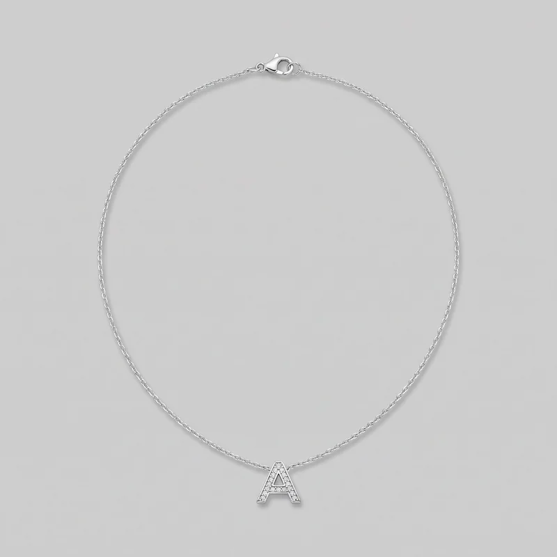 Silver-tone necklace displayed alone in a loop, with a centered outlined block capital A pendant at the bottom. The pendant has an open triangular cutout and small stone embellishment across its front, while the lobster clasp and circular jump-ring hardware are visible at the top.