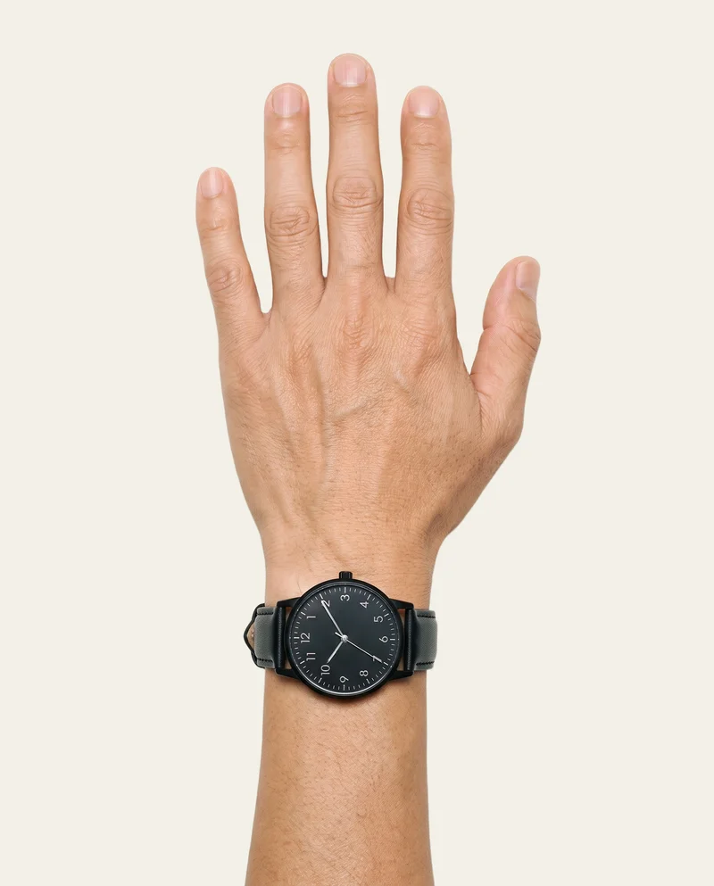 Men's Black Leather Dress Watch, Hand and wrist at Top, Studio Cutout lighting