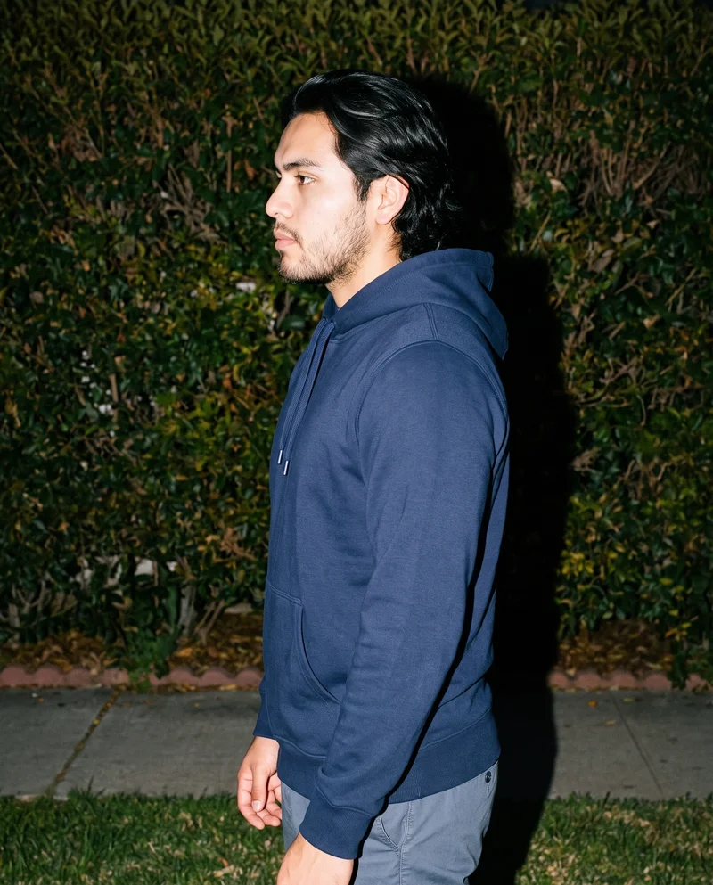 Men's Navy Cotton Pullover Hoodie, Upper body at Side, Flash Editorial lighting