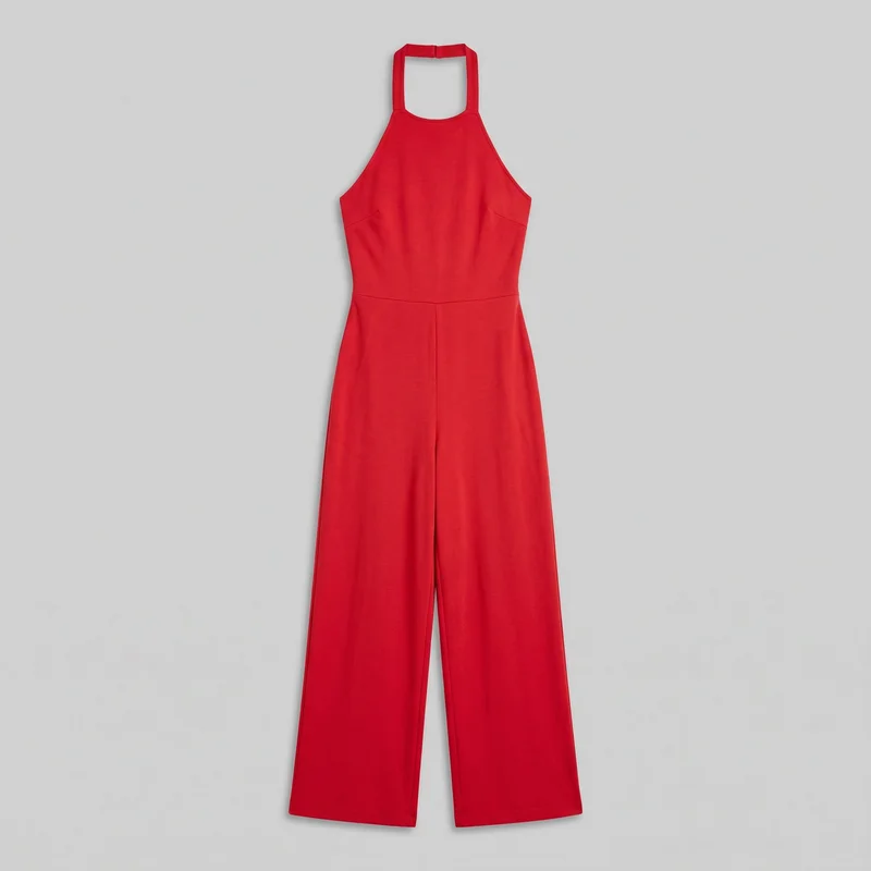 A complete red sleeveless halter jumpsuit is shown laid flat from the front. It has broad straps joined by a straight neck band, a squared open neckline, deep cutaway armholes, a fitted bodice with angled side darts, and a defined horizontal waist seam. The wide full-length pant legs hang straight with straight hems and a visible center front seam.