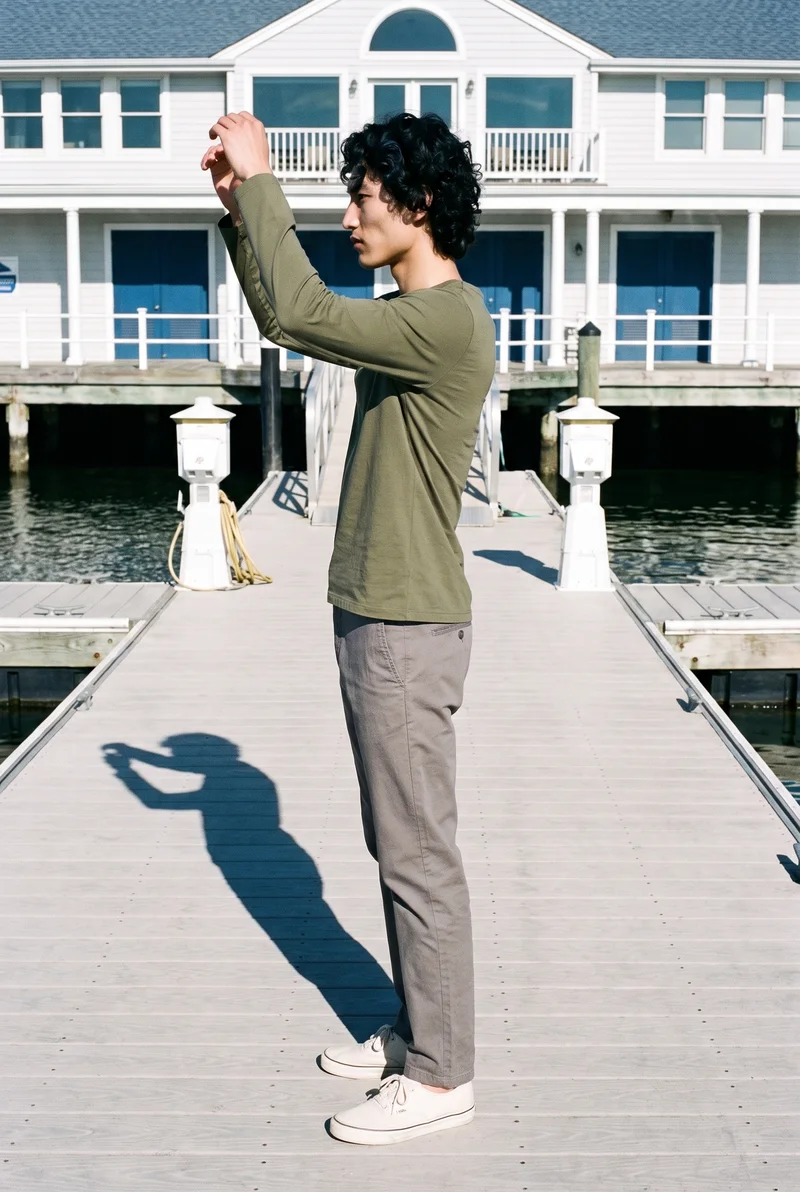 Men's Olive Cotton Long-Sleeve Tee, Full body at Side, Flash Editorial lighting