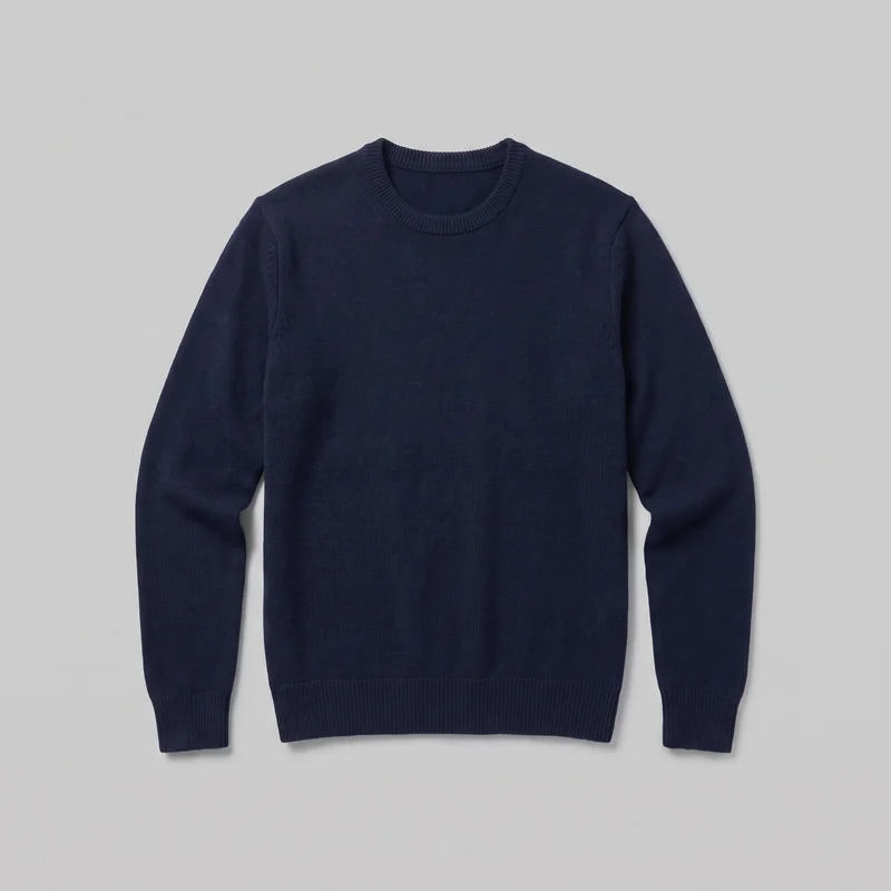 A mostly complete front view of a men's navy wool pullover sweater displayed flat. It has a regular straight silhouette, crew neckline, set-in long sleeves, wide ribbed bands at the neck, cuffs, and straight hem, and a plain knit surface with visible shoulder and armhole seams. No closures, pockets, logos, prints, patches, embroidery, or embellishments are visible.