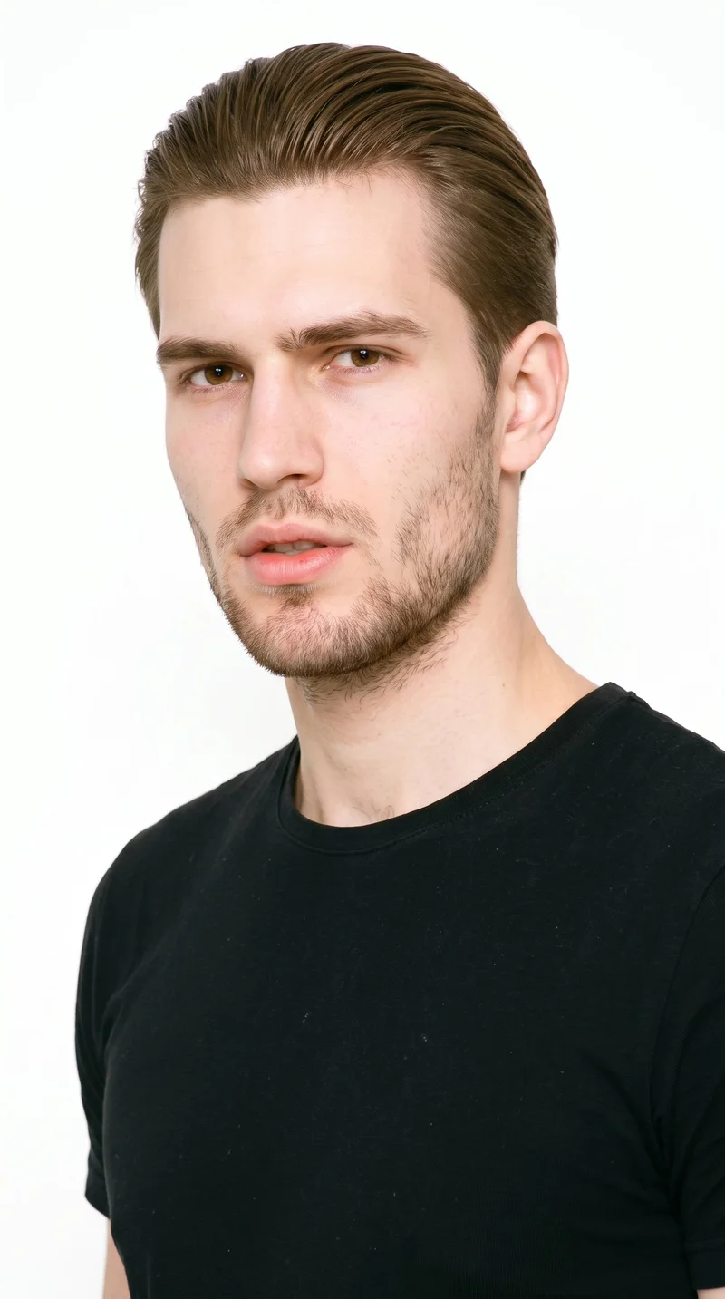 This 19-year-old Slavic man has fair skin with a peach undertone. His square face has a broad forehead and a strong, defined jaw, creating an angular, structured appearance. He has thin eyebrows, brown eyes, and thin lips. His neutral brown hair is combed flat and back off his face, close to the head. Short, even three-day beard growth creates a clearly visible, closely groomed texture along his facial hair.