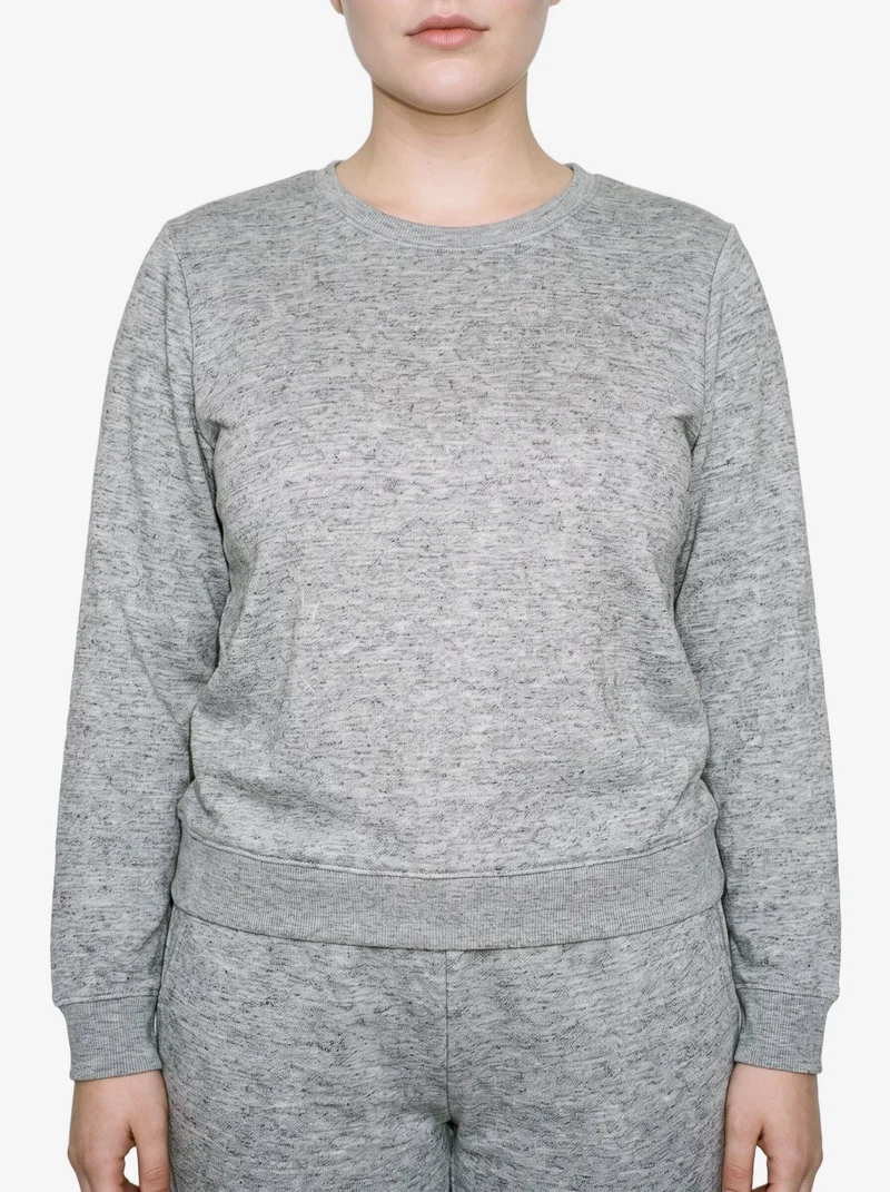 A female model is shown from the torso up in a front view, wearing a women's grey marl loungewear set with her arms relaxed. The set is presented against a flat cloud-white backdrop.