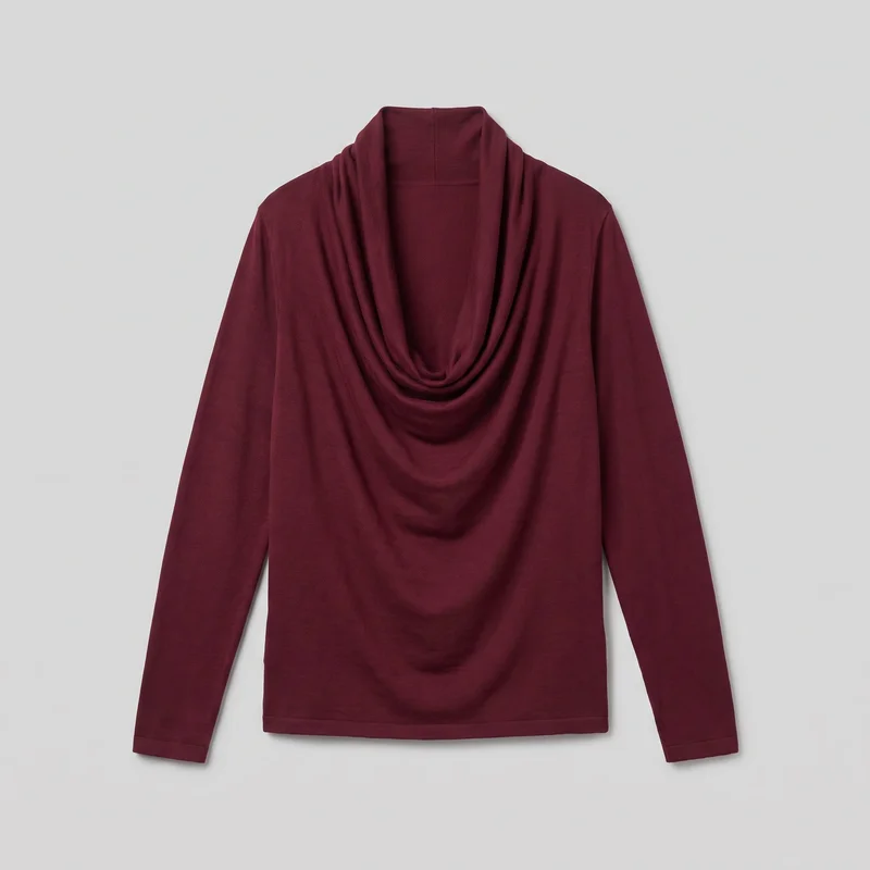 A burgundy long-sleeve knit top is laid flat in a mostly complete standalone view. The front shows a regular straight silhouette, full-length sleeves, a straight lower hem, narrow stitched hems at the cuffs and bottom, and a prominent deep cowl neckline arranged in layered draped folds.