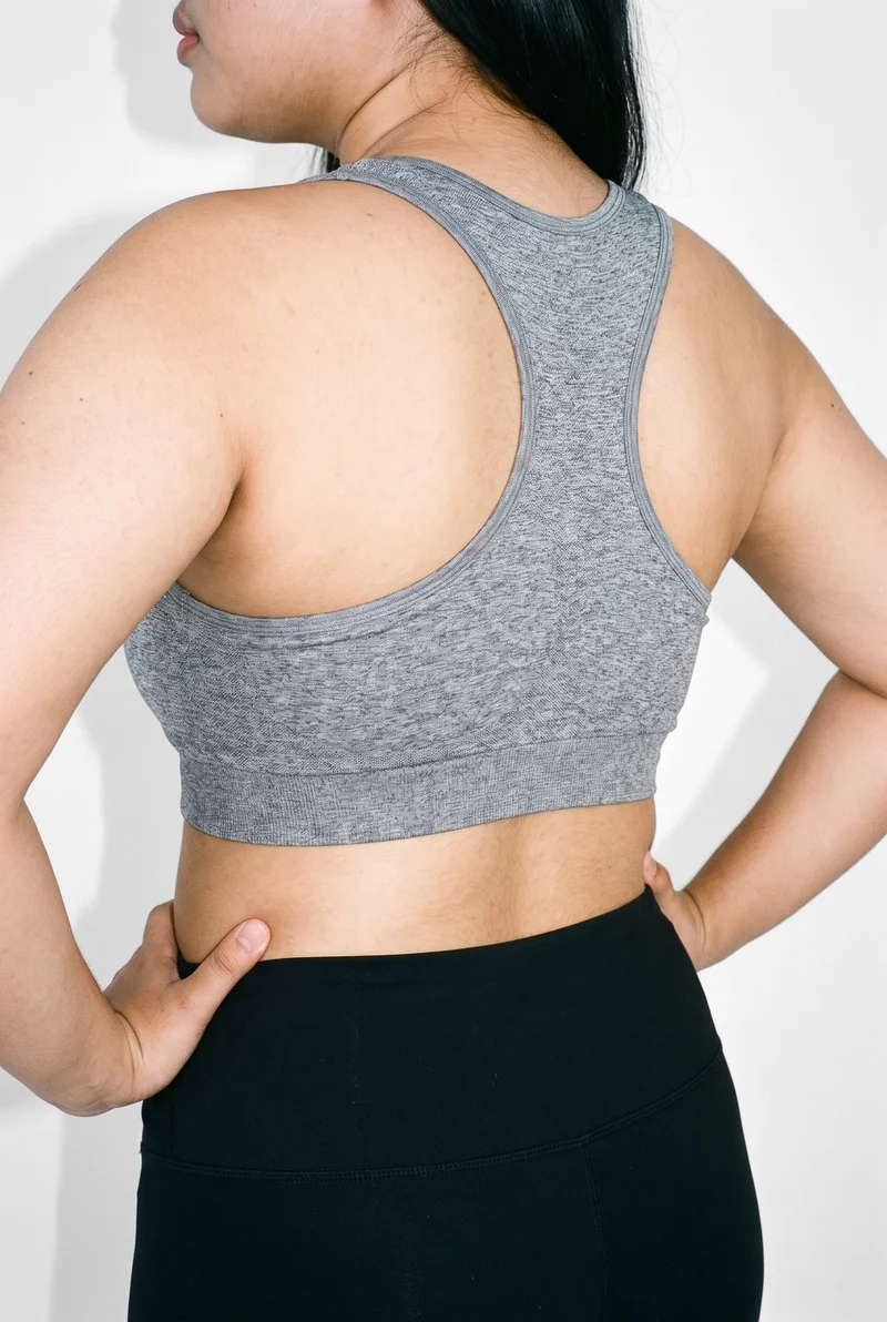 Grey Seamless Sports Bra, Torso at Angled rear, Natural E-Commerce lighting