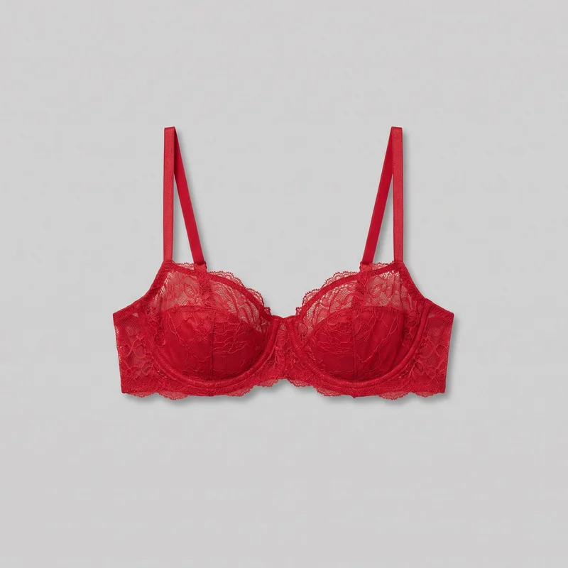 Red women's balconette bra shown laid flat in a mostly complete front view. The close-fitting underwire design has structured molded-looking cups with vertical and curved seams, a low center gore, wide side wings, a straight lower band, and flat shoulder straps attached at the outer cup edges. Sheer floral lace covers the upper cups, denser floral lace covers the lower cups, and scalloped lace edging runs along the top cup edges and lower band.