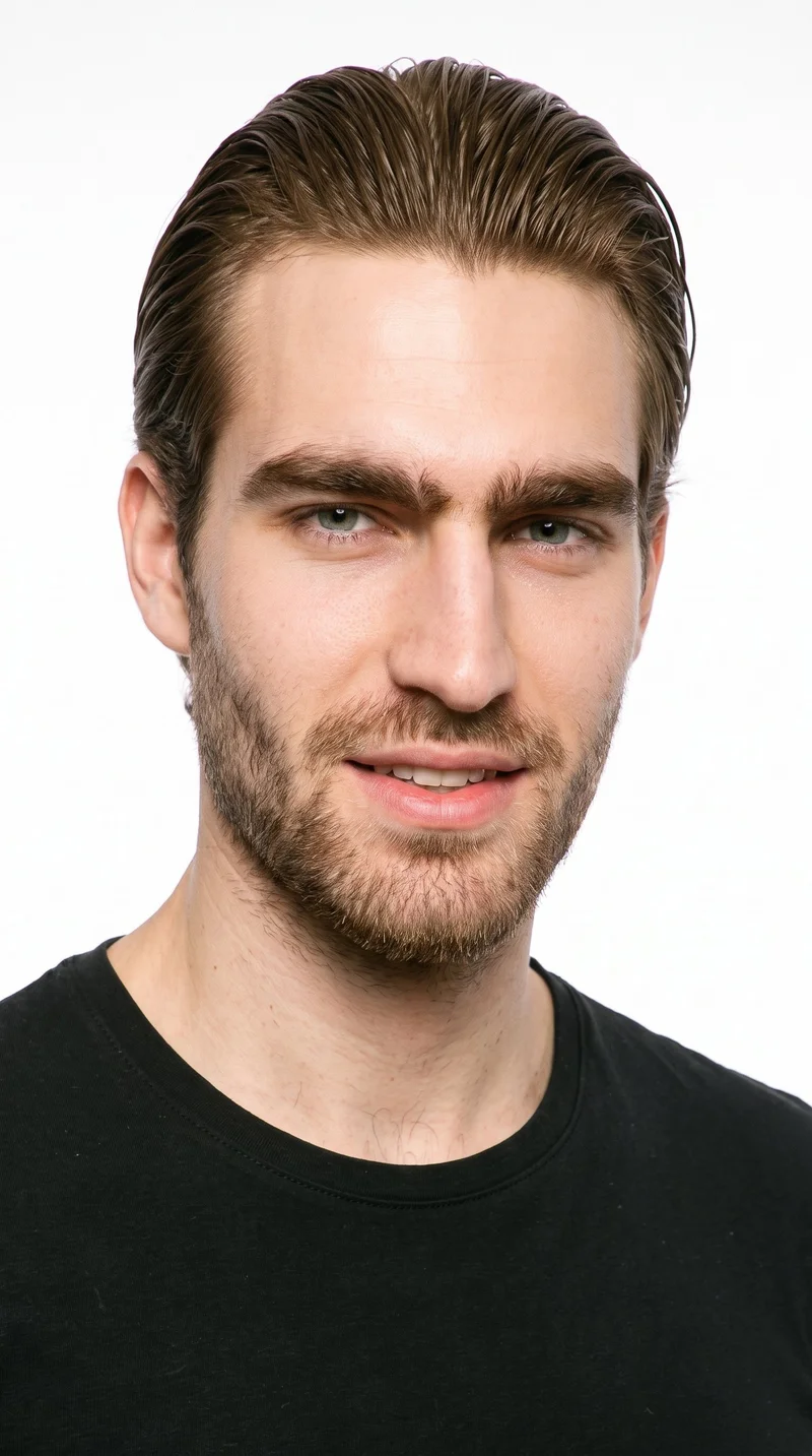 A 21-year-old Caucasian man has a medium skin tone with a warm golden undertone. His Roman face shape is defined by strong classical features, a prominent nose line, and a defined jaw. He has thick eyebrows, blue eyes with a cool undertone, and full lips. His medium-brown hair is styled close to the head with a glossy wet-look finish, and short, even three-day beard growth creates a clearly visible, closely groomed texture.