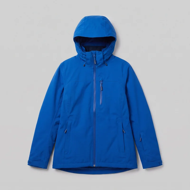A mostly complete front view of a women's blue waterproof ski jacket presented as a standalone product image. The jacket has an integrated hood with visible drawcord ends and toggles, a high stand collar, a full-length front zipper, a vertical zip chest pocket, and two lower zip hand pockets. Curved and vertical panel seams, full-length sleeves, adjustable tab cuffs, and a slightly curved drop-tail hem are visible.