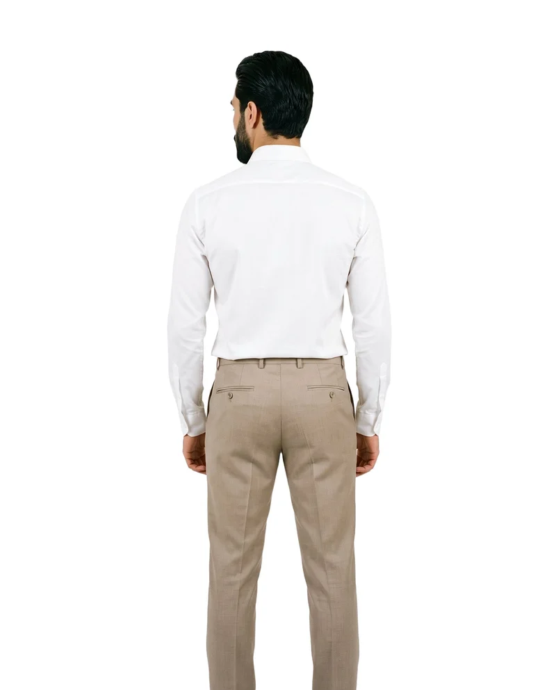 A 23-year-old Caucasian male model stands straight, shown from the rear in a three-quarter-length view, wearing beige suit trousers. The trousers are presented against a pure white backdrop.