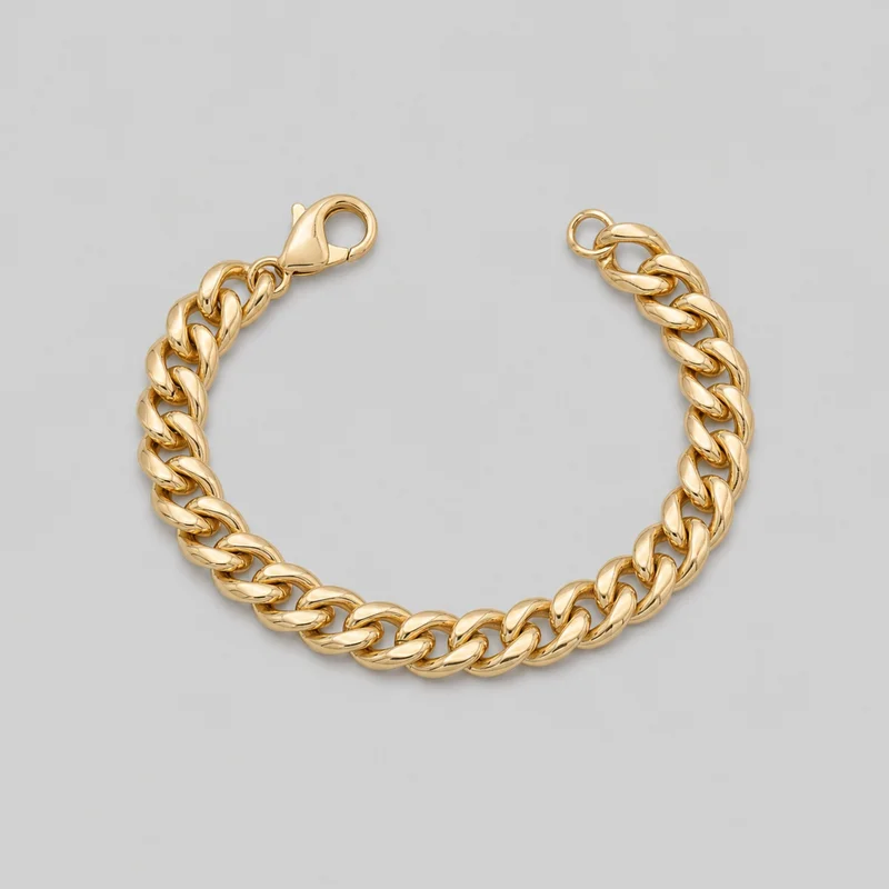 A standalone women's Cuban link bracelet is laid in a curved shape. It features rounded interlocking oval links with smooth raised surfaces and open centers, along with a visible lobster-claw clasp and circular terminal ring. No charms, logos, engraving, stones, or other embellishments are visible.