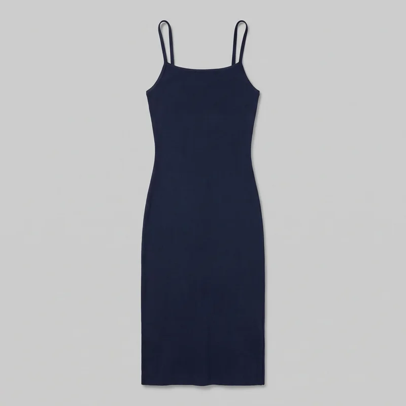 A navy ribbed knit camisole midi dress is shown in a complete flat front view. The sleeveless dress has narrow shoulder straps, a straight square neckline, low curved armholes, a slim bodycon fit through the bodice, waist, and hips, and a straight full-width hem. Vertical rib texture and minimal binding along the neckline, straps, and armholes are visible.