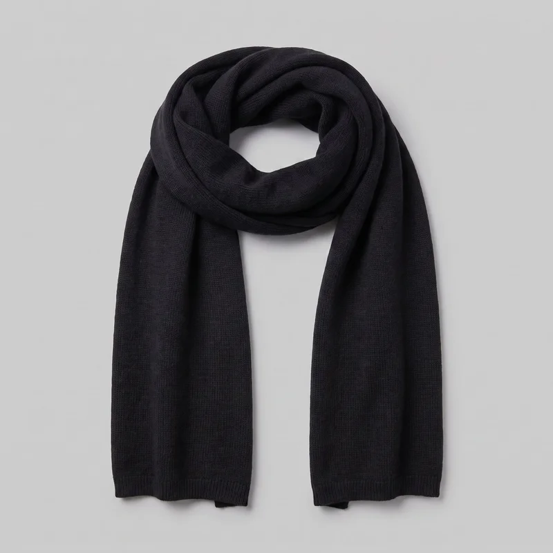 A black wool scarf is shown as a standalone product, looped near the top with two wide, straight ends hanging vertically. The rectangular scarf has a fine allover knit texture, softly folded side edges, and ribbed bands at the short end hems. No closures, hardware, logos, prints, embroidery, or embellishments are visible.