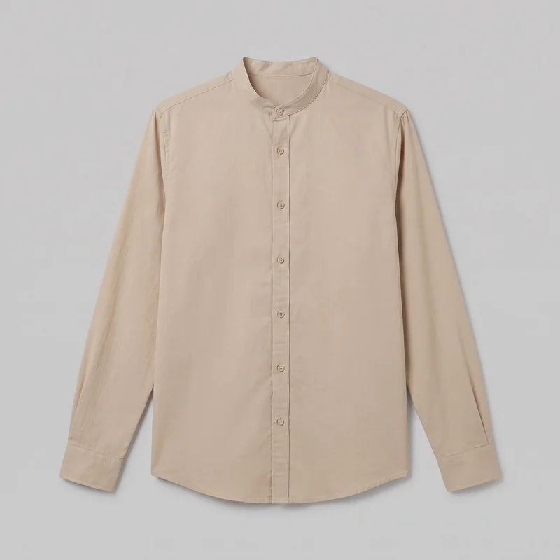 A beige cotton long-sleeve grandad shirt is shown laid flat in a complete front view. The shirt has a banded mandarin-style neckline, a narrow button placket with small round buttons, set-in shoulders, full-length sleeves with simple cuffs, visible topstitching, and a gently curved shirt-tail hem.