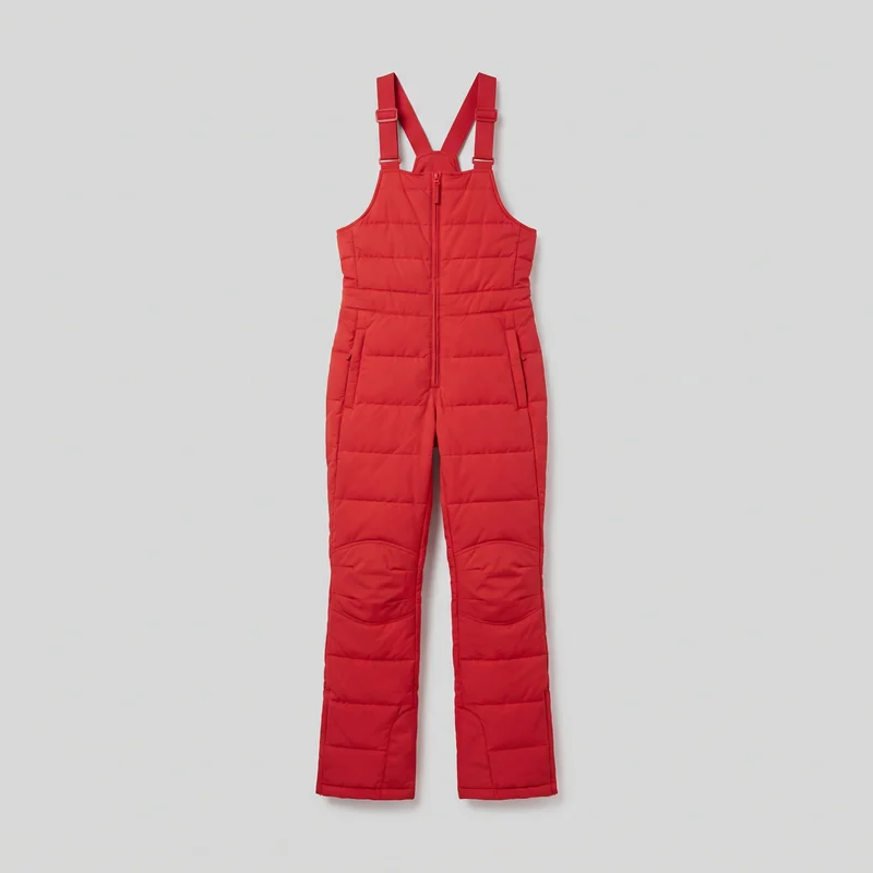 Red insulated ski bib pants laid flat in a complete front view. The relaxed-fit design has a high front bib, adjustable shoulder straps with rectangular slide buckles, a centered upper-bib-to-crotch zipper, two zippered front hip pockets, straight full-length legs, shaped knee panels, and horizontal quilted channels throughout the bib, waist, legs, and lower hems.