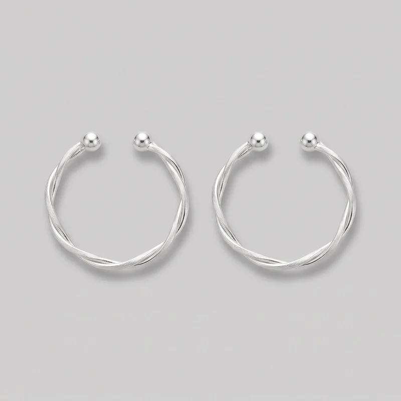 A matched pair of silver open hoop earrings is shown as a standalone product. Each rounded hoop has multiple intertwined ridged strands with alternating raised and recessed channels, tapering into smooth spherical end caps near the opening. No hooks or posts are visible.