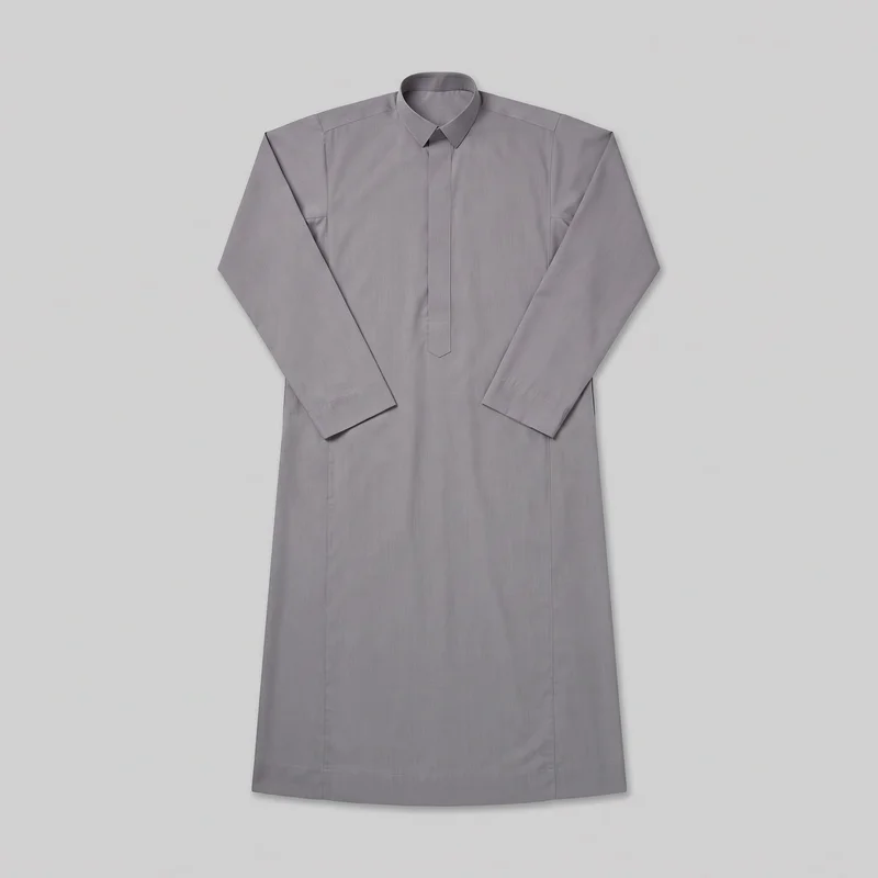 A grey cotton thobe is shown in a full front flat-lay view. It has a straight full-length robe silhouette, long set-in sleeves with simple cuffs, a fold-down pointed collar, and a concealed center placket with a narrow pointed overlay at the chest. Visible shoulder yoke, angled upper-body, and vertical front panel seams define the garment, which has a straight hem and no visible pockets, logos, prints, embroidery, patches, or embellishments.