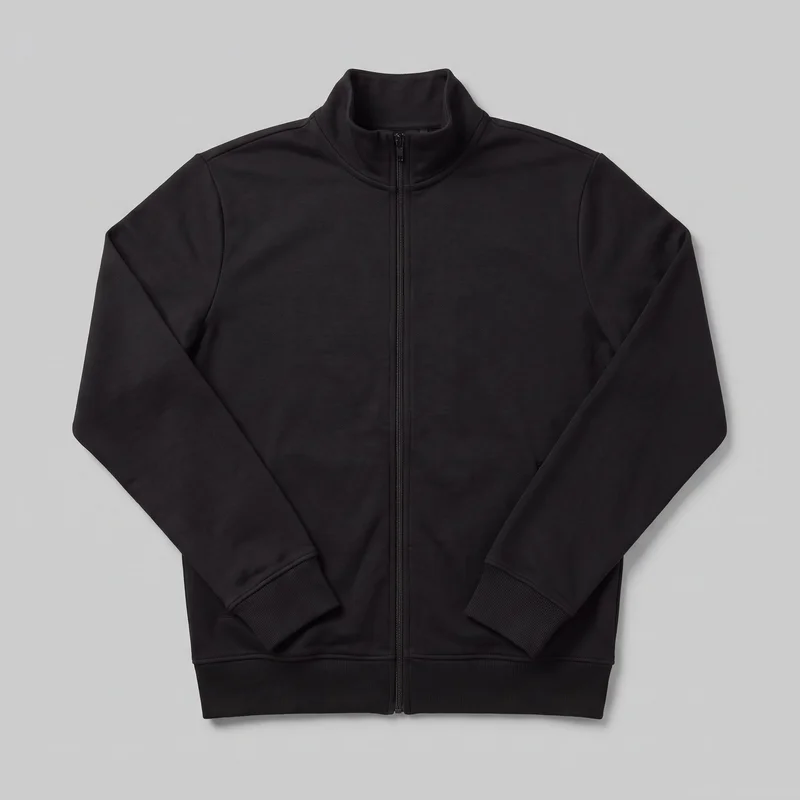 A men’s black full-zip tracksuit top is shown centered in a flat front view. It has a straight regular silhouette, full-length body, high stand collar, long sleeves, a center zipper extending from the hem to the collar, smooth front panels, visible shoulder and armhole seams, ribbed cuffs, and a ribbed bottom hem. No pockets, logos, prints, patches, embroidery, or embellishments are visible.