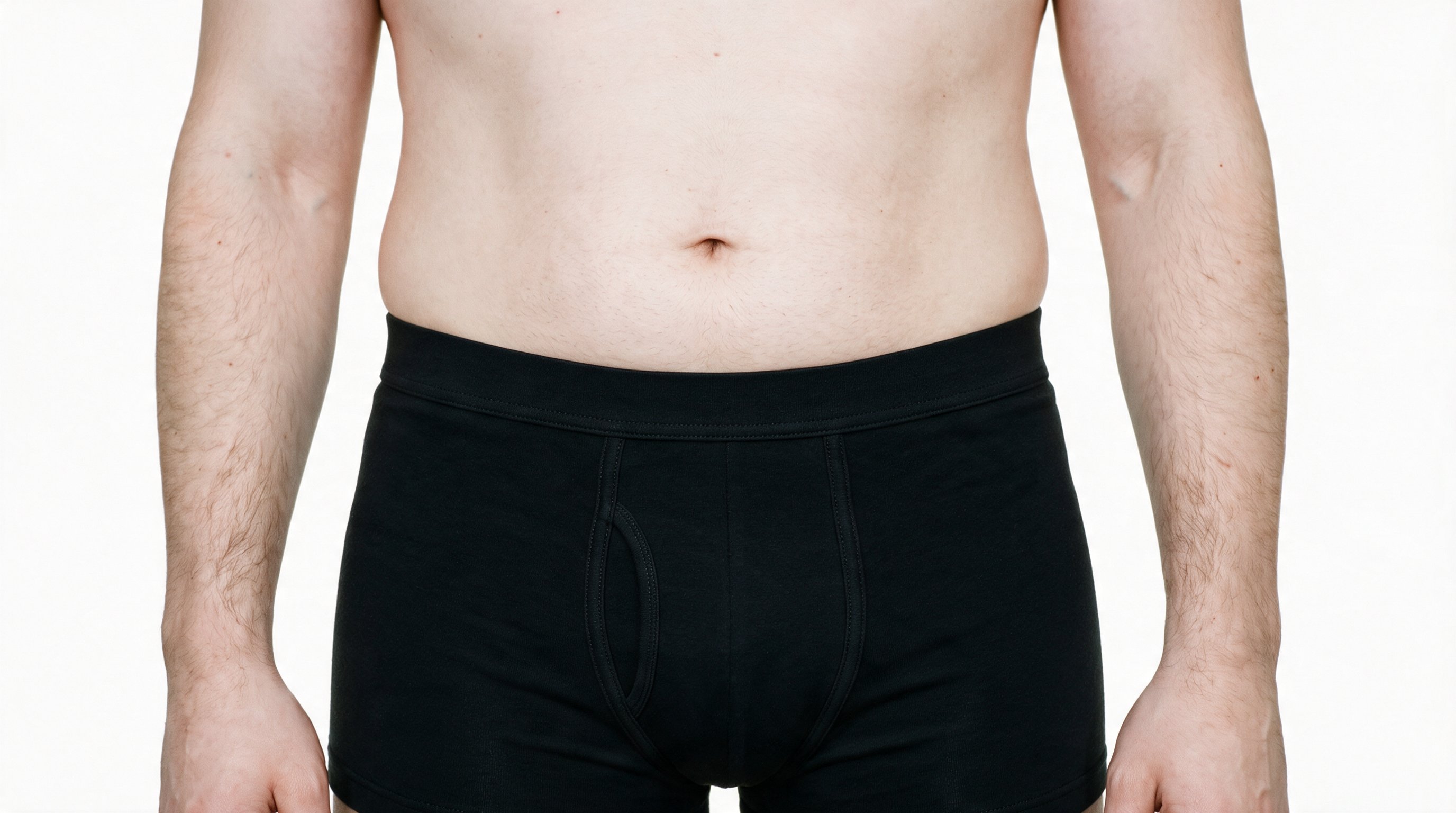 Black trunks displayed from a front view at hip level, with the hips level in the frame against a pure white backdrop.